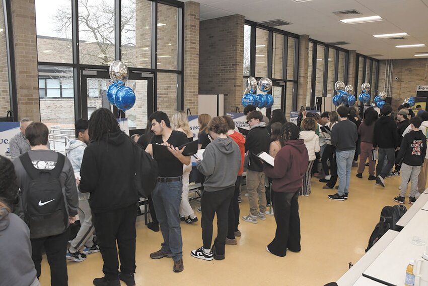 MAKING THE ROUNDS: Pi lgrim students visit consumer booths during the financial education fair sponsored by Wave Federal Credit Union.