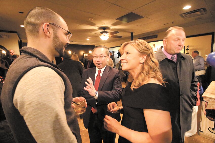 STARTING A REVOLUTION: Fenton-Fung and her husband former mayor Allan Fung laugh with supporters at her announcement party at Revolution American Bistro in Pawtuxet Village. (Warwick Beacon photo)