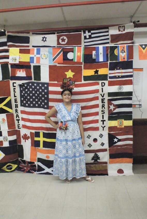 MEXICAN TRADITIONS: 6th grader Esther Fernandez wore a traditional Mexican headdress before the official multicultural night flag. (Photos by Steve Popiel)