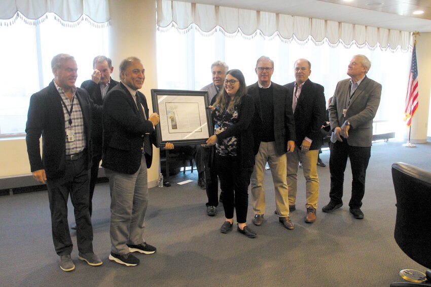 CELEBRATING HER ACHIEVEMENT: The Rhode Island Airport Corporation Board of Directors gathered for a group photo Thursday with Brittany Morgan. Morgan, RIAC&rsquo;s chief of staff, was recognized by Airport Business Magazine&rsquo;s &ldquo;40 under 40&rdquo; as one of the airport industry&rsquo;s up and coming young professionals. (Warwick Beacon photo)