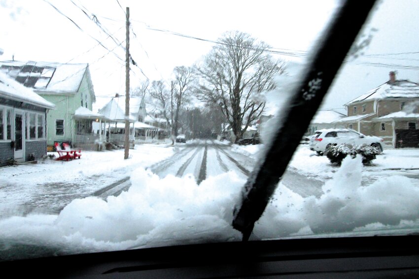 As forecast, the snow started about 5 a.m. Tuesday and heavy flakes kept falling faster and faster to the point where it was accumulating at close to 3 inches an hour. Windshield wipers had trouble keeping up, as did snow plows. Fortunately winds did not pickup as initially forecast and temperatures hovered near freezing making for a heavy slushy mush. The scene is from Bellman Avenue in Conimicut. (Warwick Beacon photo)