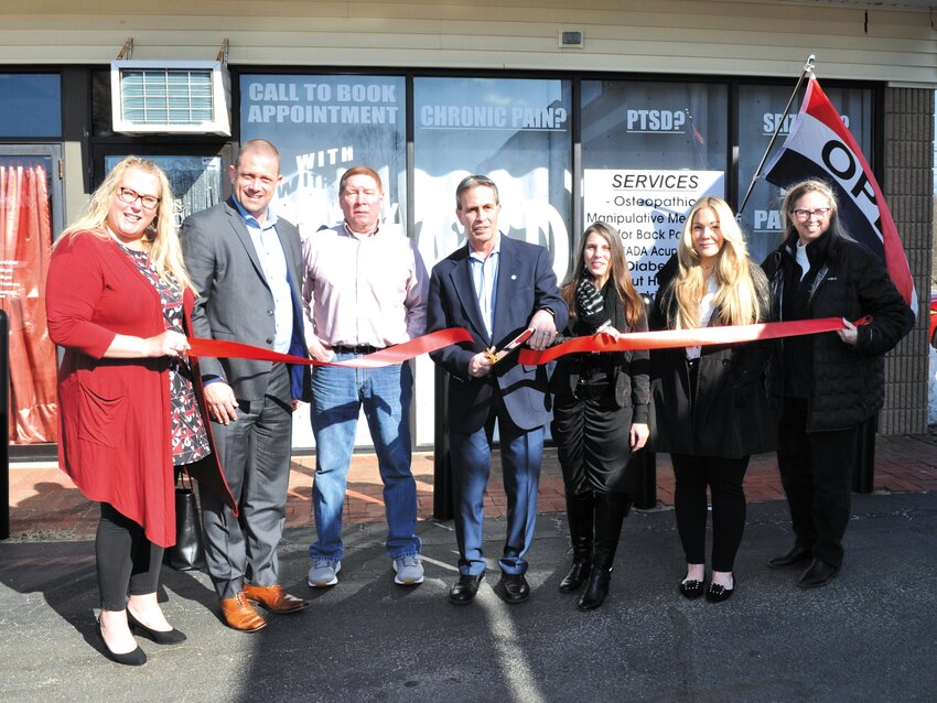 THE CEREMONY COMMENCES: Mayor Frank Picozzi prepares to cut the ribbon in front of Everyday Medicinals&rsquo; Warwick Ave. office (L-R) Central Rhode Island Chamber of Commerce (CRICoC) Director of Membership and Marketing Jennifer Wheelehon, CRICoC Chairman of the Board Michael Aurecchia, family friend Rich Chase, Picozzi, founder Amanda Cheatom, Cetrified Health Coach Amanda Prado and CRICoC CEO Lauren Slocum. (Photo courtesy of Lev Poplow)