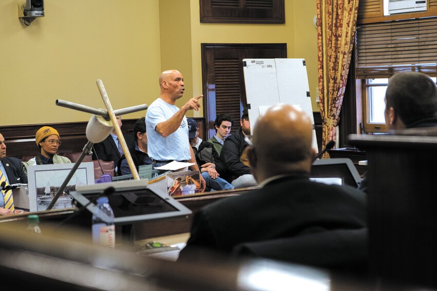 V\CATCHING THEIR ATTENTION: Warwick quahogger Jody King came armed with a rake, lots of photos and his personal experiences documenting a decline in quahog catches. He spoke Tuesday before the Special Legislative Commission studying a decrease in quahog catches. (Warwick Beacon photos by Will Steinfeld)