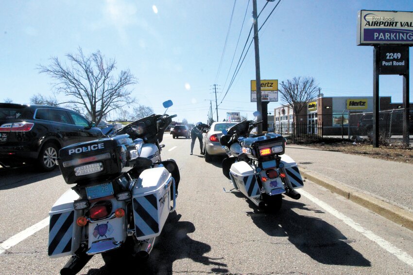 SOME FRIENDLY ADVICE: Officer Jacob Elderkin offers advice to a motorist following a stop on Post Road. (Photo courtesy of Officer Nicholas DiNardo)