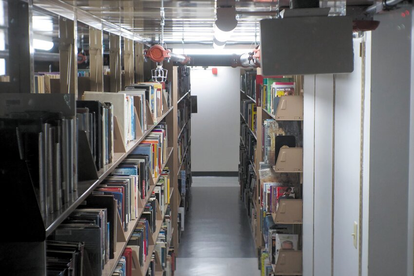 The price libraries pay for physical books have largely stayed the same, barring regular increases from inflation. But The physical books seen here in the basement of the Providence Public Library likely aren&rsquo;t as in high demand as certain e-books, with some digital titles having hundreds of holds. (Alexander Castro/Rhode Island Current)