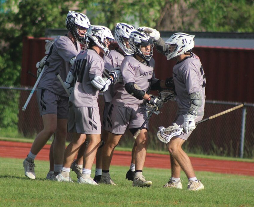 BACK TO THE FINALS: Members of the Pilgrim boys lacrosse team celebrate after scoring a goal in the first quarter on Tuesday night. (Photos by Alex Sponseller)