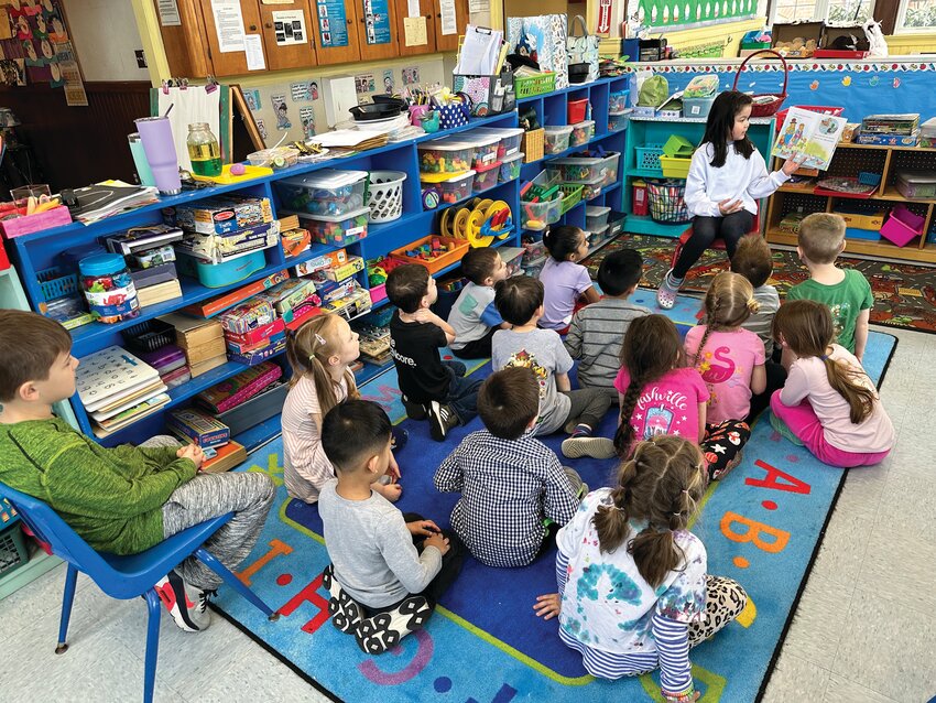 ALUMNUS VISIT: A Little Shepherd graduate returns to read a story to this year's class. (Photos courtesy Emmett Hare)