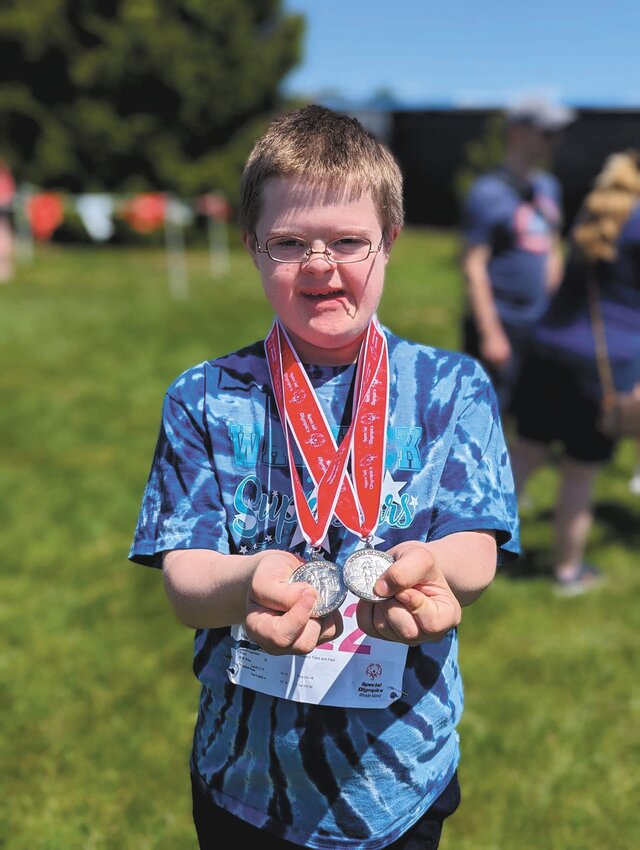 PROUD ATHLETES: Zain Rohena, dressed in the Warwick Superstars&rsquo; tie-dye blue uniform, poses with a medal