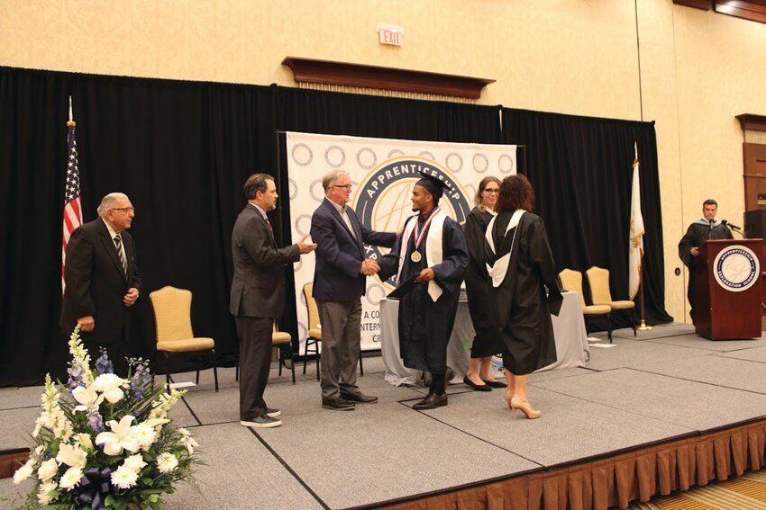 NUMBER ONE: Valedictorian Dylan Cruz receives congratulations from Mayor Ken Hopkins.  (All photos courtesy of Cranston Public Schools)