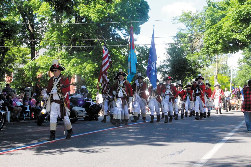 IN THE LEAD: This year the mace reportedly made from wood from the Gaspee topped with an eagle recovered from a Civil War battlefield, usually carried by a dignitary in front of the parade, was exchanged by Pawtuxet Rangers. Seen here, leading off the exchange is Lt. Col. Phil Rowell who is hopeful of being named colonel next spring in a change in command. (Beacon photos by John Howell and Felictas Stuebing)