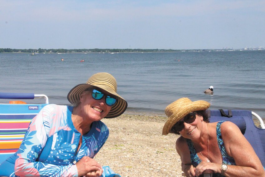 BEACH HOLIDAY: Susie Bourdeau and Deb Saccoccio relax on the beach Wednesday, enjoying the day off from work. (Warwick Beacon photos)