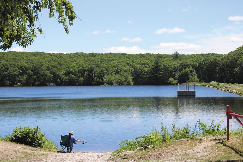 MORNING TROUT: One patron of the John L. Curran Fishing Area in Cranston tries to reel in some trout using nightcrawlers as bait on a sunny Thursday morning.