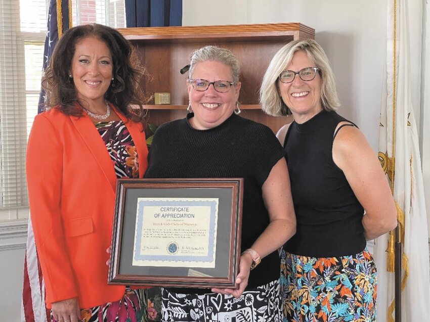 REACHING OUT: Boys and Girls Club of Warwick Executive Director Karin Kavanagh (center) receives a certificate of appreciation from DHS representatives Kimberly Merolla-Brito (left) and Laurie Cote. (Submitted photo)