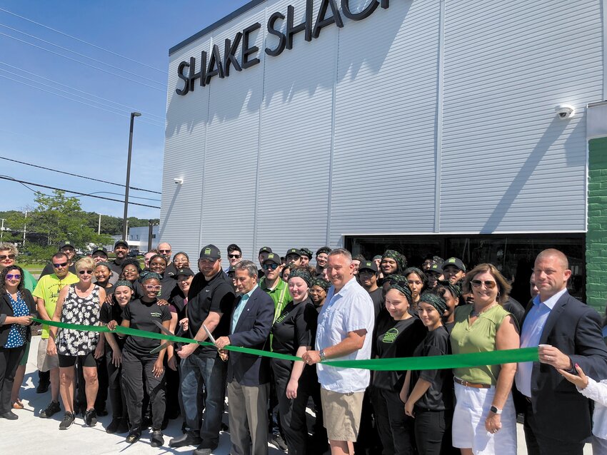 THE OPENING DAY TEAM: City and Shake Shack employees gather together as Mayor Frank Picozzi prepares to cut the ribbon officially opening the restaurant. (Warwick Beacon photos by Adam Zangari)