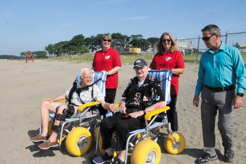 BEACH ACCESS:  Sisters Jeanne Muto-Kyle and Pat Andrade, who run the Joey Andrade Foundation, and Mayor Frank Picozzi with Beacon Editor John Howell, who uses a walker these days and Frederick Potter demonstrate the chairs available for use at Oakland Beach. It was Potter&rsquo;s post on social media that initiated the effort of the Joey Andrade Foundation to buy and donate the chairs to the city for public use. (Warwick Beacon photos by Barbara Polichetti)