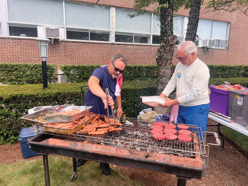 GRILLING AND CHILLING: David Sardinha and Chad Johnson man the BBQ grills at the Praise Tabernacle Church&rsquo;s annual Hope for the Homeless day on July 14. (Courtesy photos)