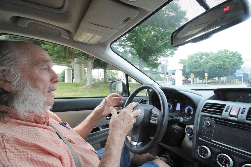 CAN IT MAKE IT?: Richard Langseth, pictured behind the wheel, questions how tractor trailer trucks can pass beneath the flyway to departure gates at T. F. Green Airport. (Warwick Beacon photos)