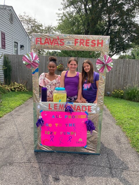 LEMON-AID: (L-R) Braylin Battis, Ava Williams and Sophia Harrison stand behind their lemonade stand in Williams&rsquo; driveway. (Warwick Beacon photo)