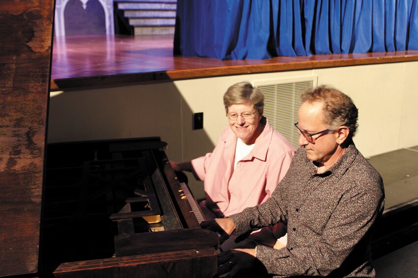 LIFELONG MUSICIAN: Retired musician and actor Ralph Petrarca tests the keys on the piano after it had been transported to the Warwick Vets auditorium. The 7-foot long grand piano was delivered to Warwick Vets by the Avery Piano Company in Providence.