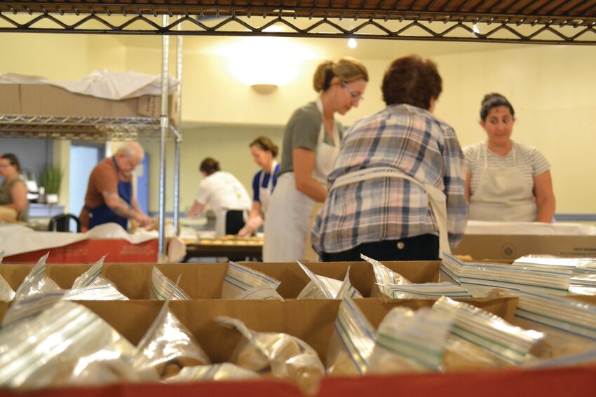 GETTING READY: Experienced bakers packed the Greek Orthodox Church of the Annunciation Social Hall at 175 Oaklawn Ave. in Cranston on Tuesday, Aug. 27. The festival&rsquo;s slated for Sept. 6-9. (Cranston Herald photos by Rory Schuler)