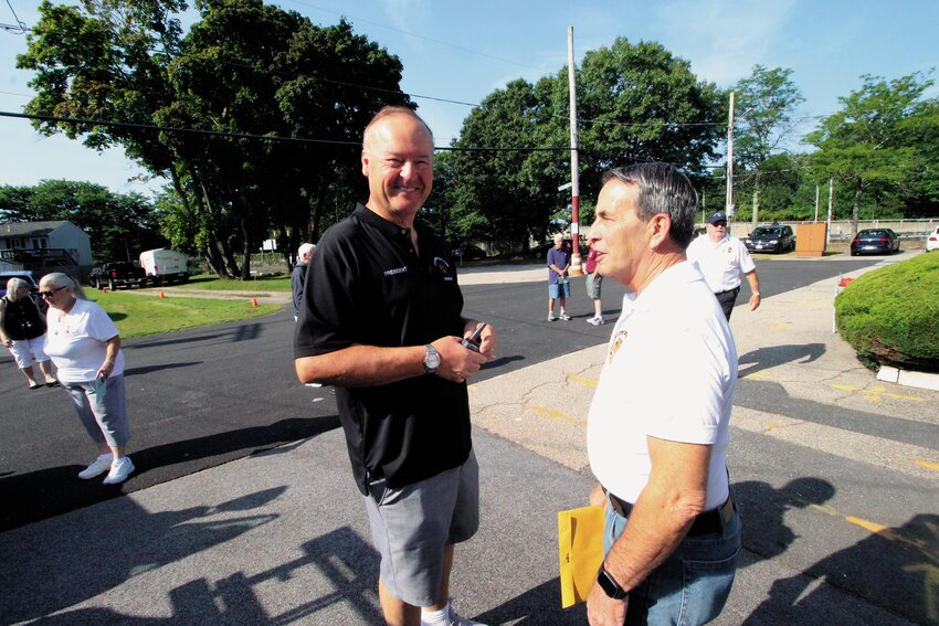 SHARING A BIT OF HISTORY: Bob Carlow, president of the Greenwood Volunteer Fire Company, and Mayor Frank Picozzi talk prior to the commencement of the Aug. 24 ceremony commemorating the company&rsquo;s 100th anniversary.