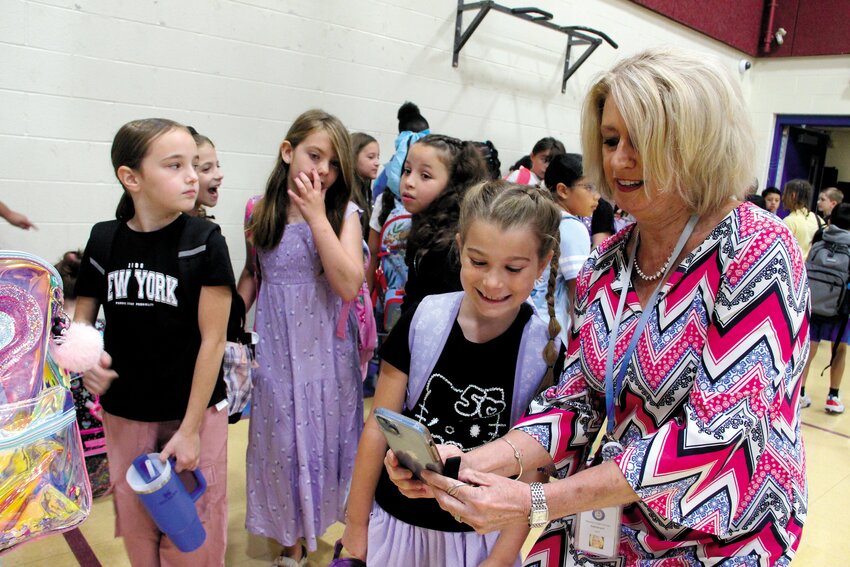 School administrators started the opening of school last Thursday with a visit to Oakland Beach Elementary that for the last academic year was relocated to Gorton during renovations. It was an occasion for taking pictures as Superintendent Lynn Dambruch demonstrated as she snapped a selfie with third grader Anna Smith. She was not alone. When we asked families to share their first day photos on Facebook, we received scores of pictures. You&rsquo;ll find lots of smiling kids on page 16. (Warwick Beacon photo)