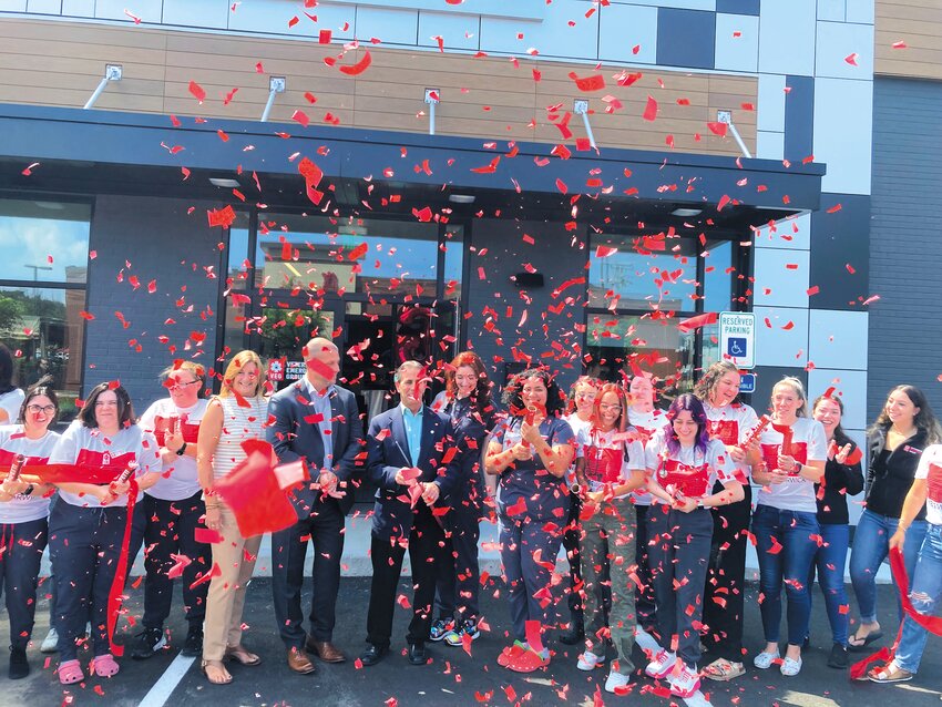 CELEBRATION TIME: Confetti falls as VEG employees celebrate after Mayor Frank Picozzi cut the ribbon officially opening the Warwick location.