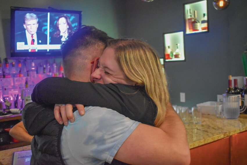 DISTRICT 42: House District 42 Democratic primary winner Kelsey Coletta hugs campaign manager Ben Branchaud during an election results/presidential debate watch party at Lemongrass restaurant in Warwick on Tuesday, Sept. 10, 2024.