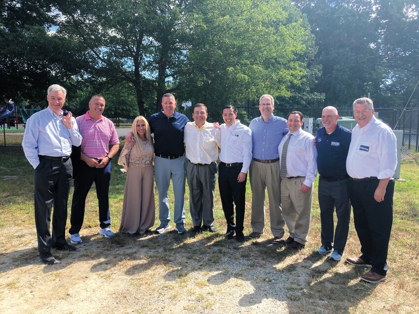 LIPPITT LINEUP: (L-R) U.S. Sen. Sheldon Whitehouse, West Warwick Rep. Thomas Noret, mayoral candidate Leah Hazelwood, House District 26 candidate Earl Read III, Speaker of the House Joe Shekarchi, Treasurer James Diossa, Ward 6 Candidate William Muto, Senate District 29 candidate Peter Appollonio, School Committee Candidate Sean Wiggins and State Sen. Mark McKenney pose outside of Lippitt Elementary School.