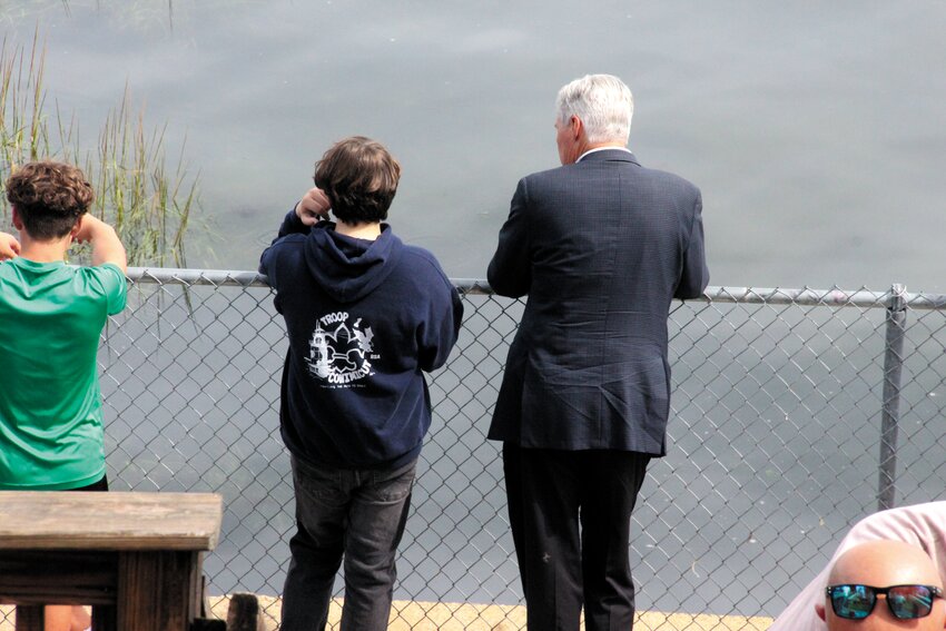 CONFERRING WITH A SENATOR: U.S. Sen. Sheldon Whitehouse gets the details from T.J. Murray on what it took to assemble the crew and materials to refresh the Conimicut Point overlook for his Eagle badge project.