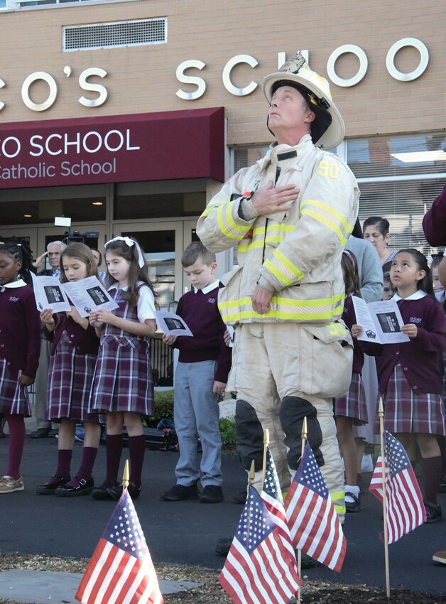 THE PLEDGE: Johnston Fire Battalion Chief Tom McCormick places his hand over his heart during the Pledge of Allegiance. (Cranston Herald Photos by Barbara Polichetti)