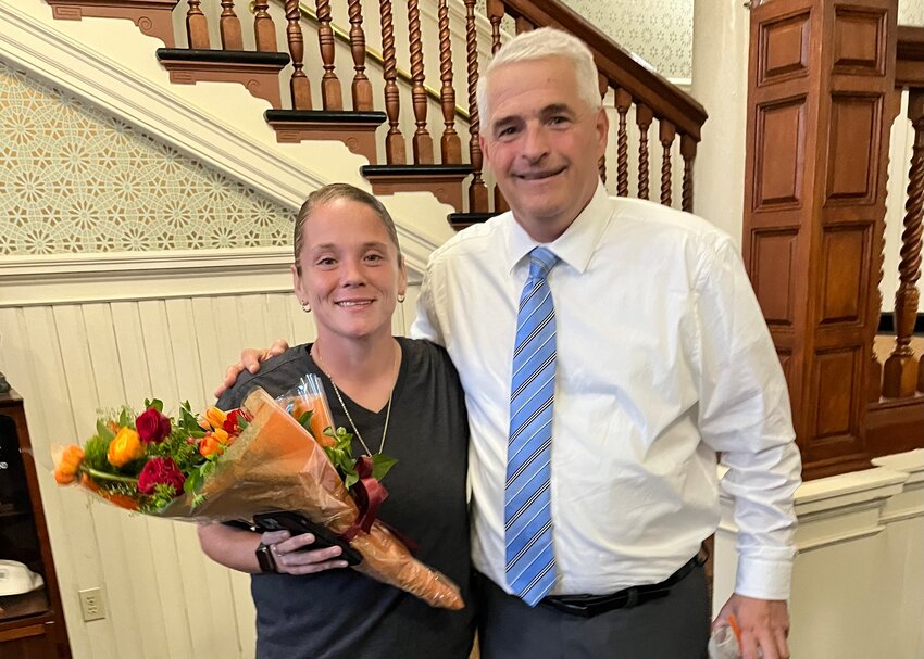 HER WORK IS RECOGNIZED: Warwick Postmaster John Bence poses with Riverview mail carrier Jessica Collins who was honored at Monday&rsquo;s night&rsquo;s City Council meeting. Scores of Riverview residents turned out for the presentation. (Submitted photo)