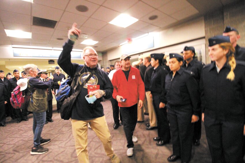 HIGH VOLTAGE LEADERSHIP: George Farrell strikes up the band (a fife and drums corps) in 2022 as veterans entered the terminal at T.F. Green International Airport. (Cranston Herald file photo)