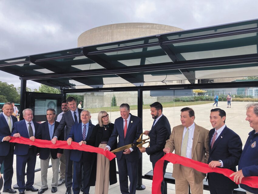 OPENING THE STATION: (L-R): West Warwick Rep. Thomas Noret, City Councilman James McElroy, Mayor Frank Picozzi, Warwick Rep. Joe Solomon Jr., Warwick Sen. Matthew LaMountain, U.S. Sen. Jack Reed, CCRI Interim President Rosemary Costigan, Gov. Dan McKee, RIPTA Interim CEO Chris Durand, Speaker of the House Joe Shekarchi, Treasurer James Diossa and City Councilman William Foley prepare to cut the ribbon opening the upgraded bus stops.  (Warwick Beacon photo)