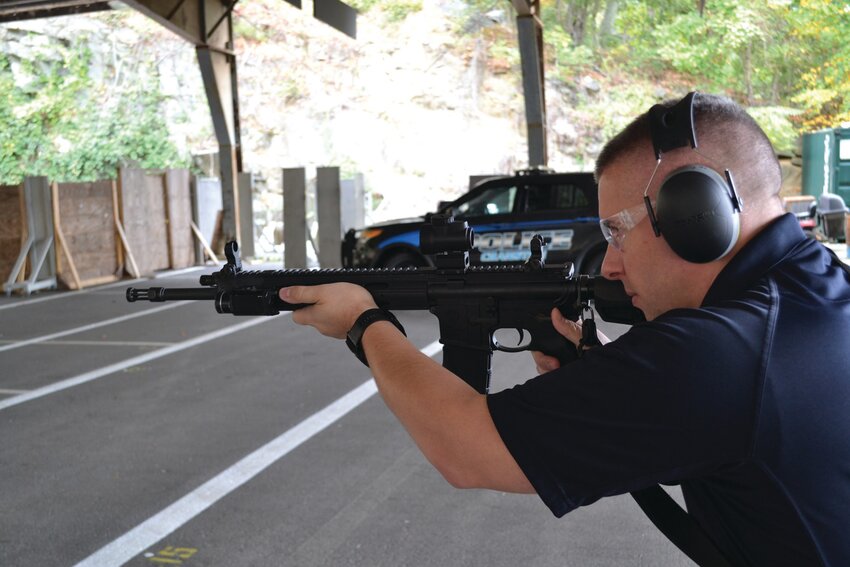 ON THE RANGE: Cranston Police Lt. Joshua Dygon held an “AR style” semiautomatic rifle tight against his shoulder last week and wore noise-cancelling headphones to protect his hearing. City officials are split on whether to relocate or enclose the range, which is located near two city schools.