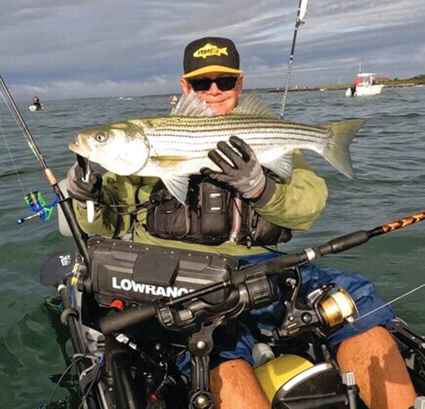 CATCHING DINNER: Tom Houde of West Warwick with a keeper striped bass he caught and took home for fish chowder last Friday at Brenton Reef off Newport. (Submitted photo)