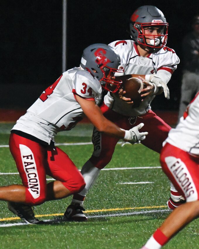 MIDSEASON GRIND: West’s Kelan Cornell hands the ball off to David Boscia. (Photo by Leo van Dijk/rhodyphoto.zenfolio.com)