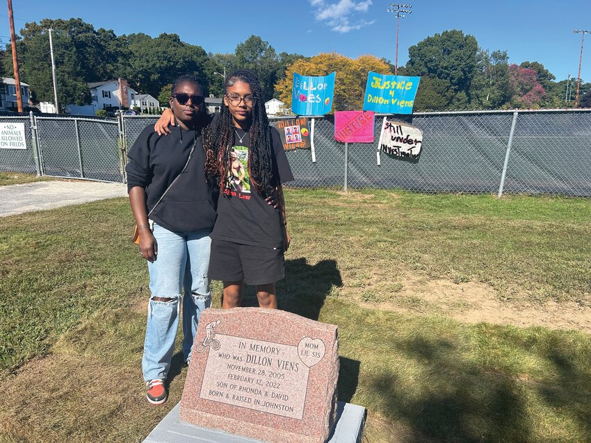 SIGNS FOR JUSTICE: The family of Dillon Viens unveiled a granite stone at Johnston Memorial Park, in his memory last weekend. Family and friends gathered last weekend to remember Dillon; they hung signs on the fence near the park’s newest memorial.