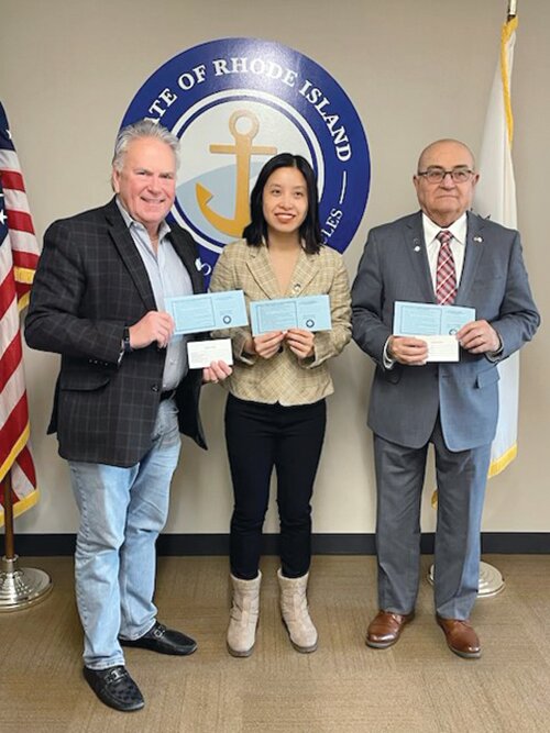 DMV Administrator Walter Craddock (left), state Sen. Victoria Gu and state Rep. Samuel A. Azzinaro with the blue envelopes and emergency contact cards that will be given to any driver who opts into the program.