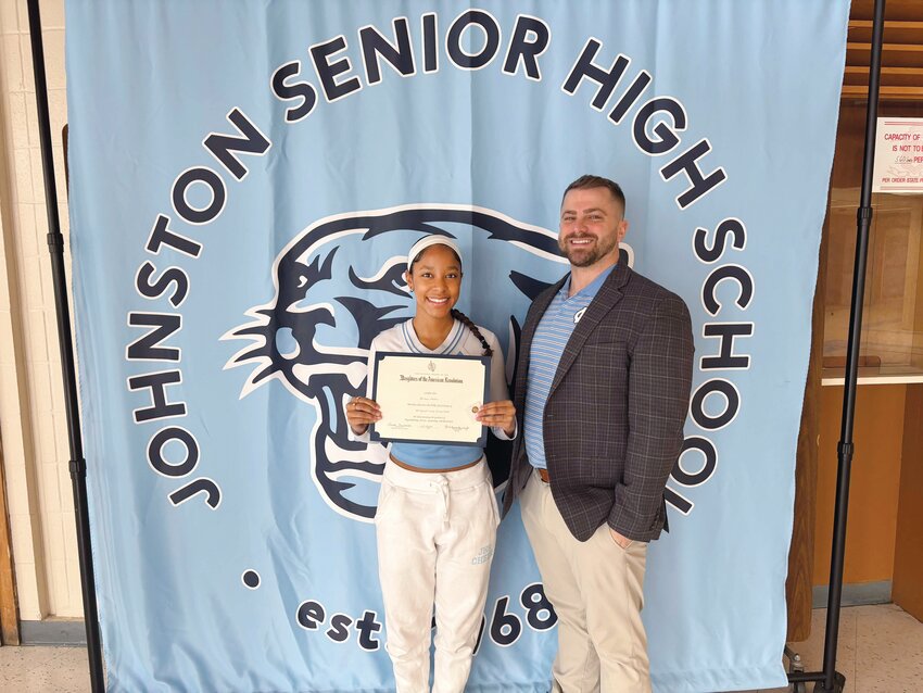 Daughters of the American Revolution Good Citizens Award recipient Dariana Mu&ntilde;oz showcases her award with Johnston Senior High School Principal Matthew Velino.