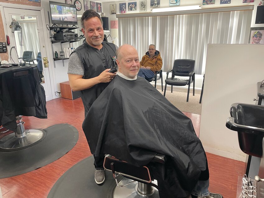 Meet Dave Picozzi, the owner of David&rsquo;s Greenwood Barber Shop, and his longtime friend, Glen Motto. Glen has been coming here for a long time, following in the footsteps of his late father, and bringing his teenage sons in to continue the tradition!
