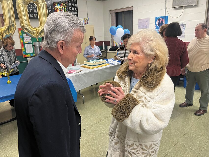 Bob Pirraglia and Bernadette Conte of Cranston catch up during Friday&rsquo;s festivities. She took a moment to remembered those who built the church, including her grandfather, Antonio Cardi and her father Cosmo Capotosto.