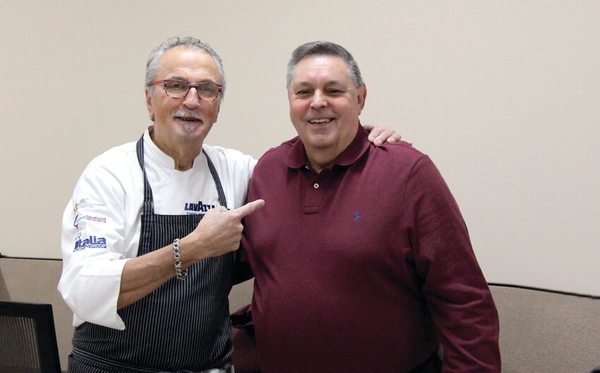 Master Chef Walter Potenza (left) gives Johnston Senior Center Director Richard DelFino kudos for NOT adding sugar to his spaghetti sauce.