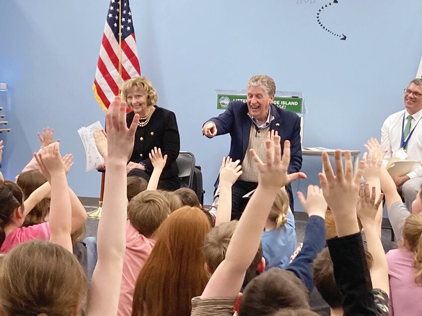 Gov. Dan McKee celebrates as a student correctly answers a trivia question about the number of cities and towns in Rhode Island.