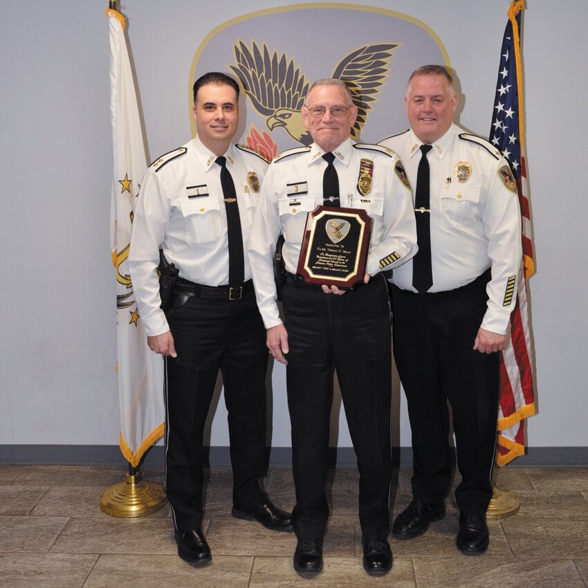 Major Thomas Dolan is joined by Chief Mark Vieira and Deputy Chief Matthew LeDuc during his retirement celebration at the Johnston Police Department.