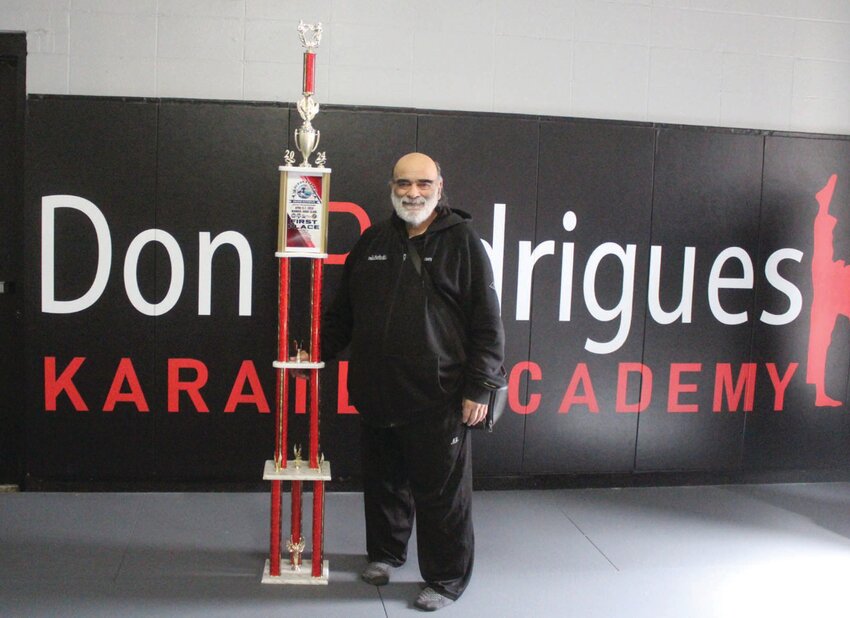 Don Rodrigues shows off one of the 7-foot-tall trophies that will be handed out this weekend. Beacon Media photo by Alex Sponseller