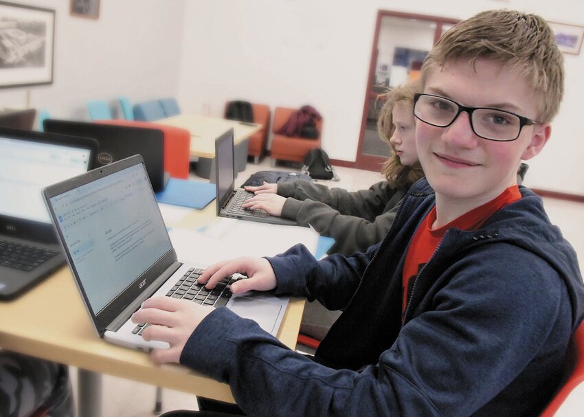 Cranston West student Clayton Dilello types away at his latest letter to his pen pal at the Cranston Senior Center.