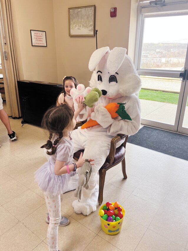 Caitlin, age 6, of Johnston was waiting patiently for her friends to arrive to visit the Easter Bunny together. “I love the Easter Bunny,” she said while holding her favorite stuffed animals.