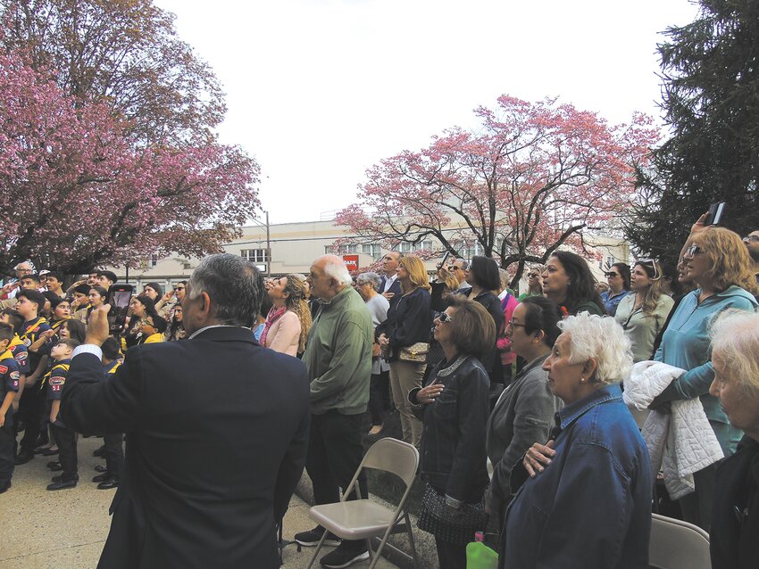 The crowd sings the Armenian national anthem as the Armenian flag is raised.