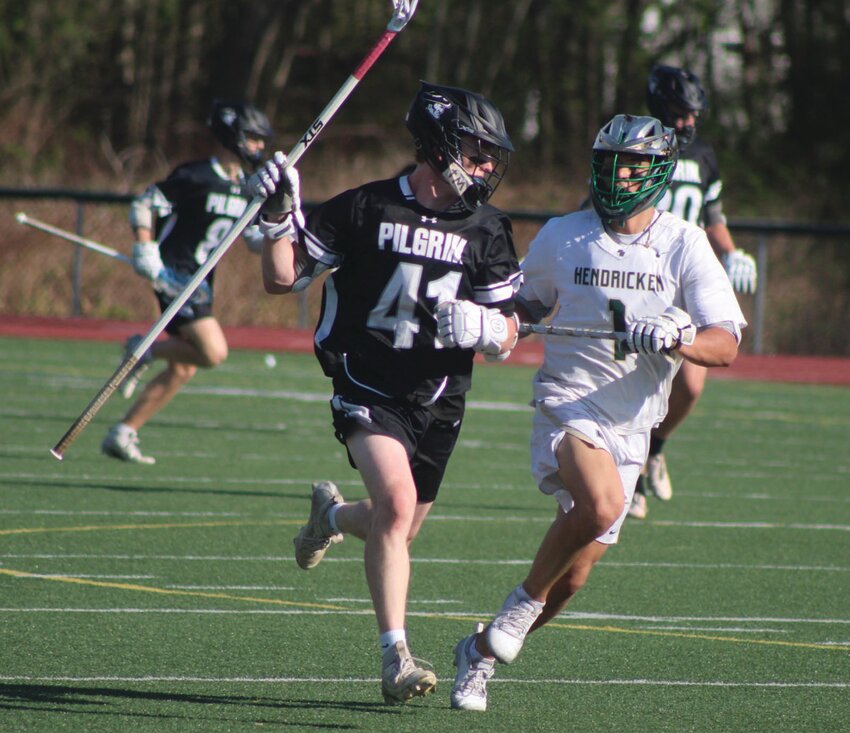 Hendricken&rsquo;s Sebastian Nault chases down Pilgrim&rsquo;s Liam Holmes. Beacon Media photos by Alex Sponseller